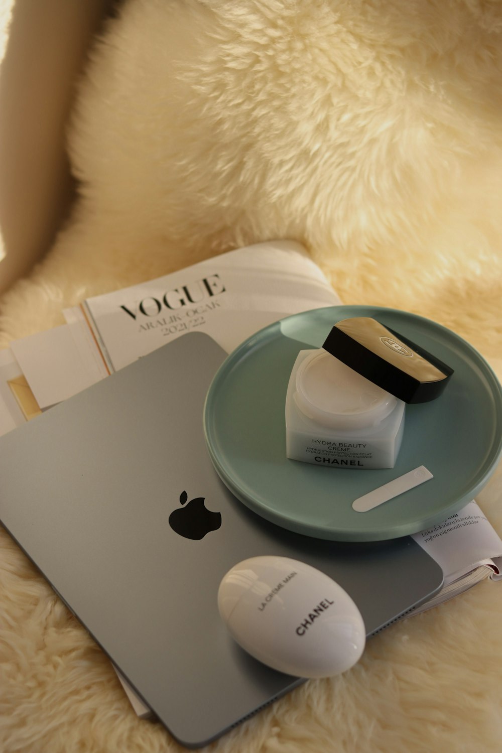 a white teddy bear sitting next to a laptop