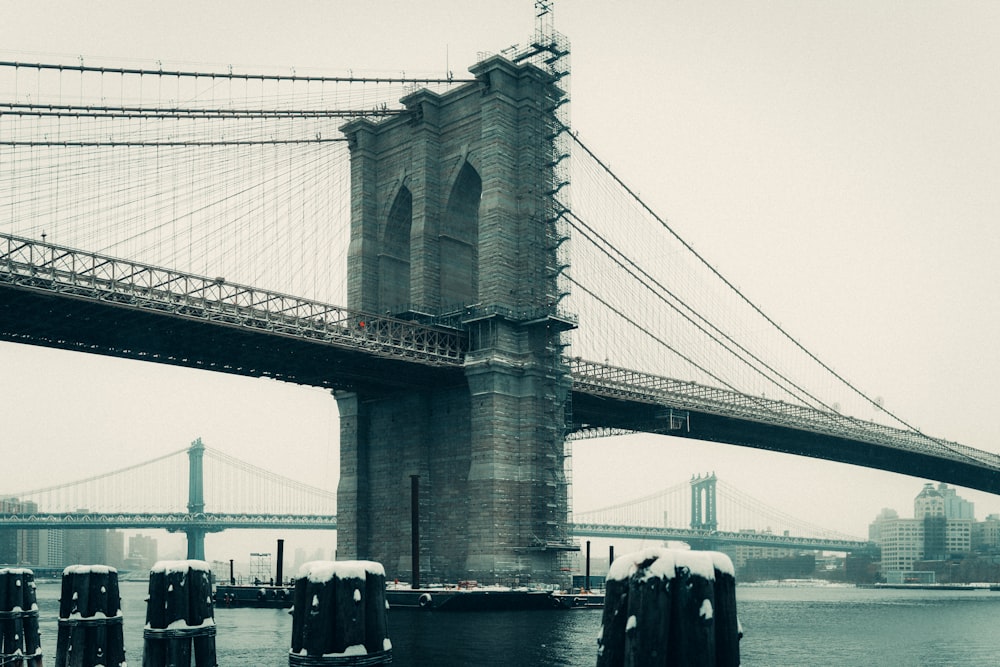 a view of the brooklyn bridge in the snow