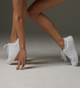 a close up of a person wearing tennis shoes