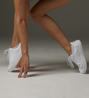 a close up of a person wearing tennis shoes