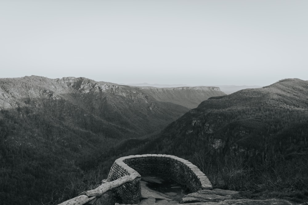 a black and white photo of a stone bridge