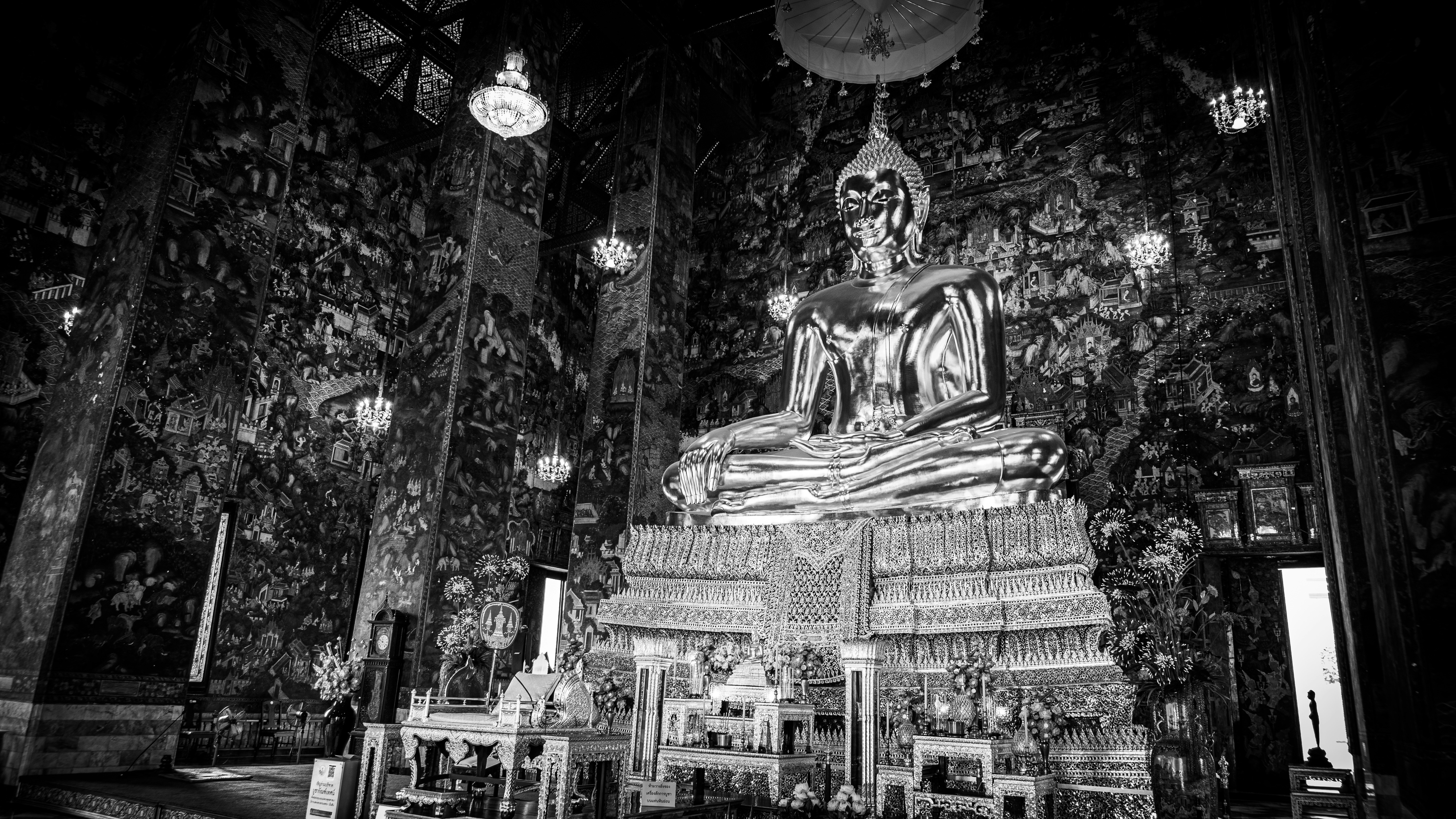 a black and white photo of a buddha statue