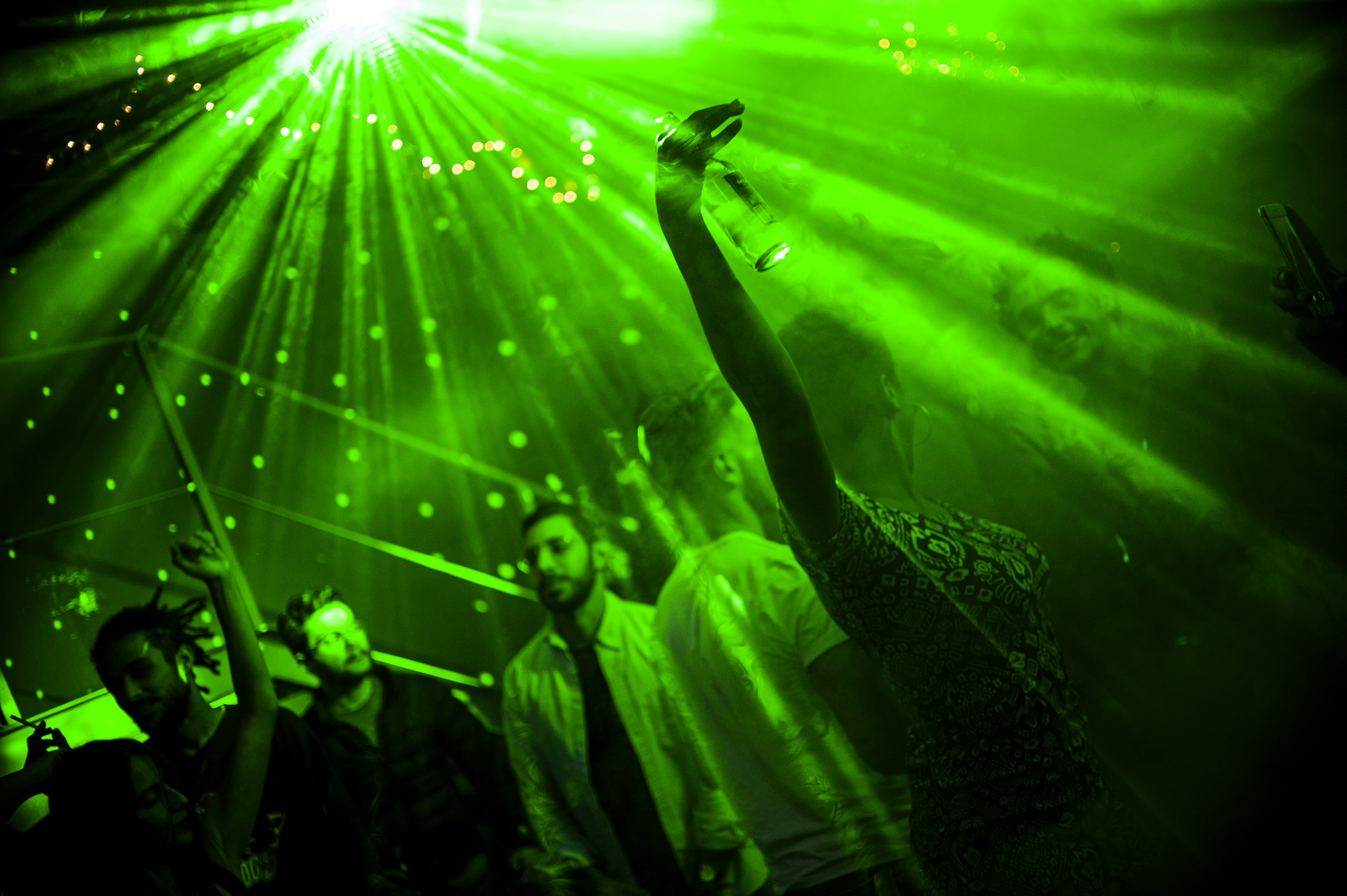 a group of people standing in front of a green light