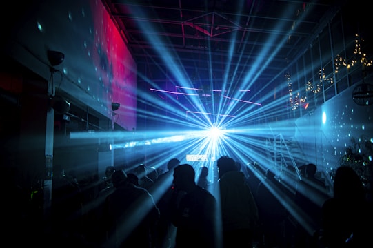 a group of people standing in a dark room