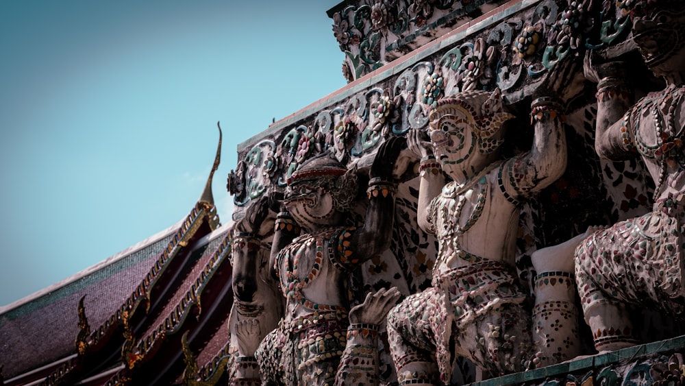 a close up of some statues on a building