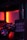 A dimly lit room features a toy car with detailed rims in the foreground, partially illuminated by a red and orange glow. A sign is hanging nearby that reads 'What happens in the man cave stays in the man cave.' The environment suggests a cozy and private atmosphere.