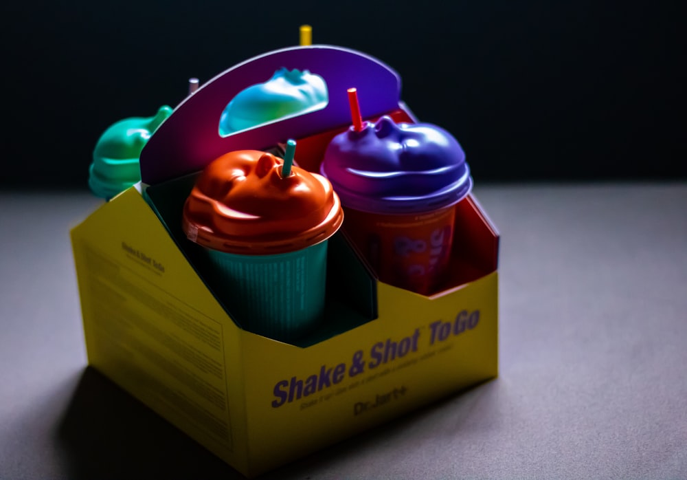 a cupcake box with three cups in it