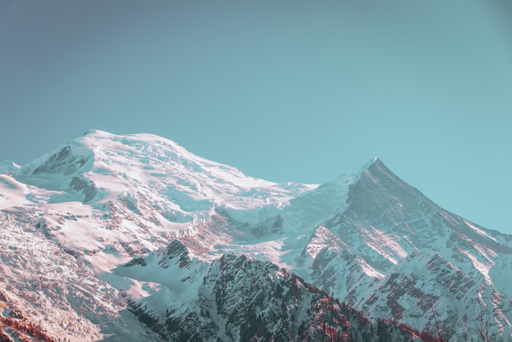 a mountain covered in snow under a blue sky