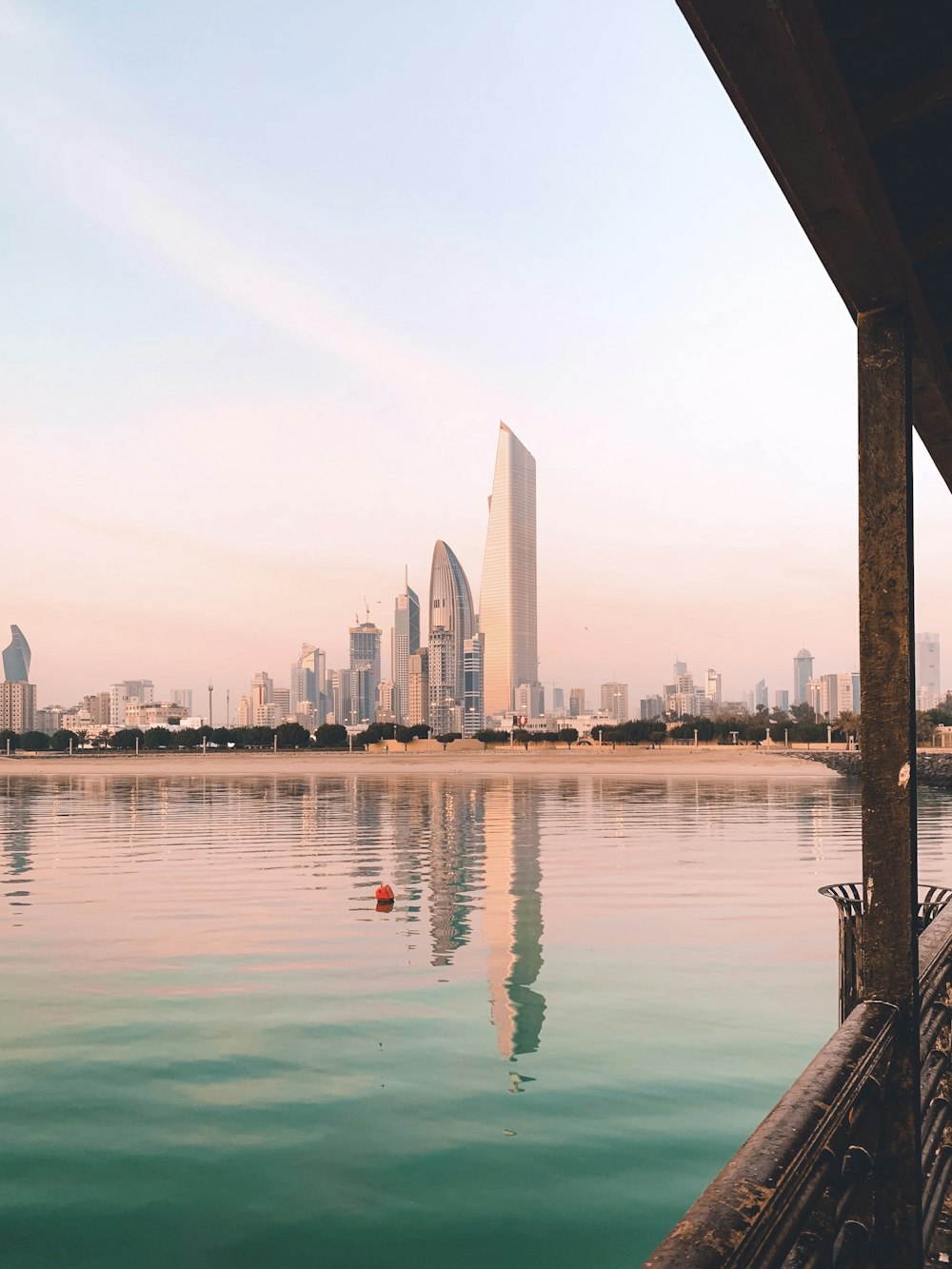 a body of water with a city in the background