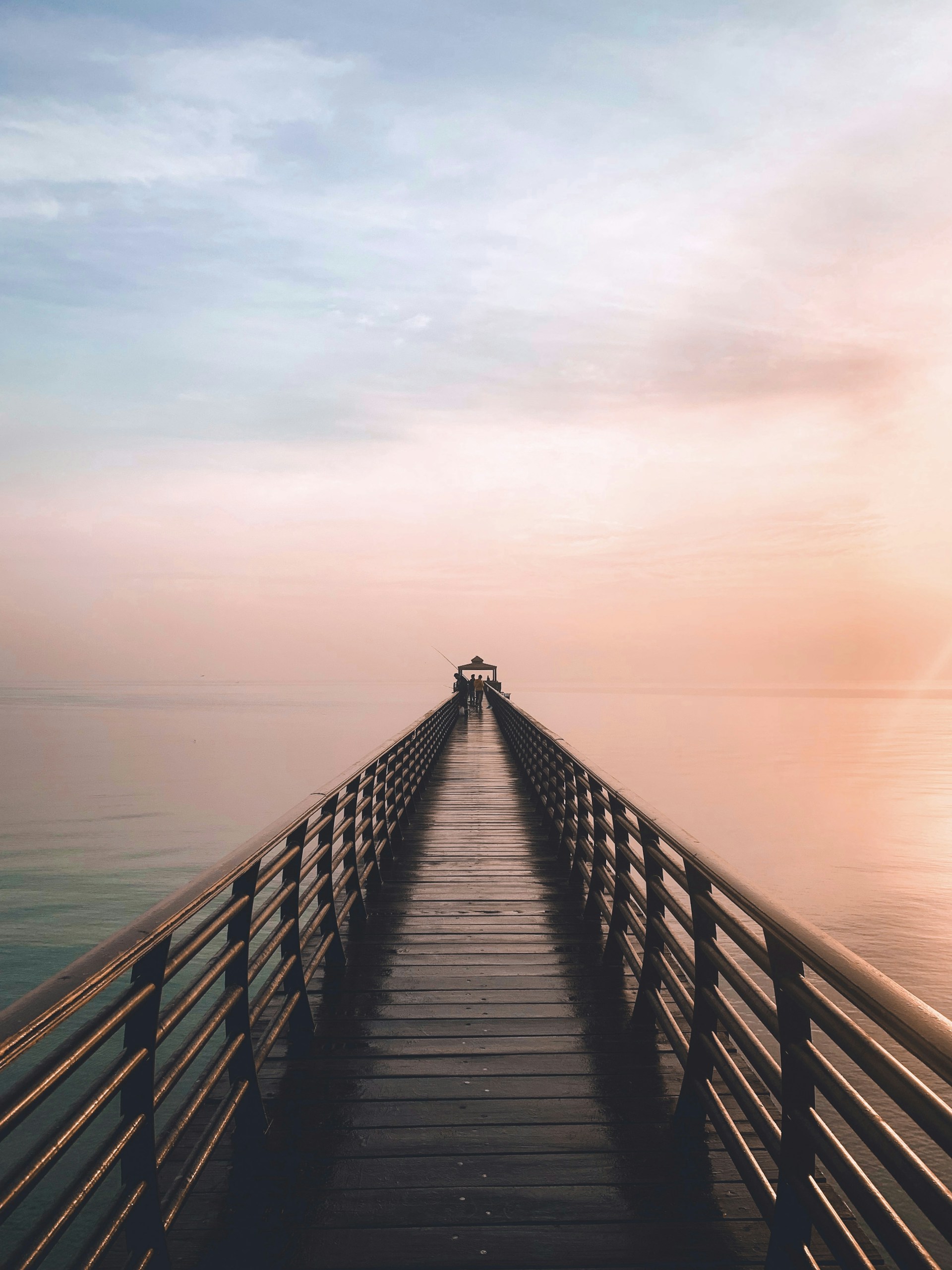 a long pier stretching out into the ocean