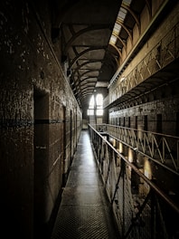 a long hallway with a light at the end of it