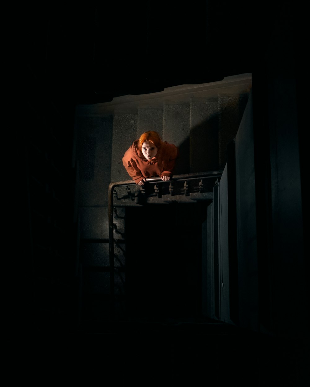 a clown sitting on top of a table in the dark