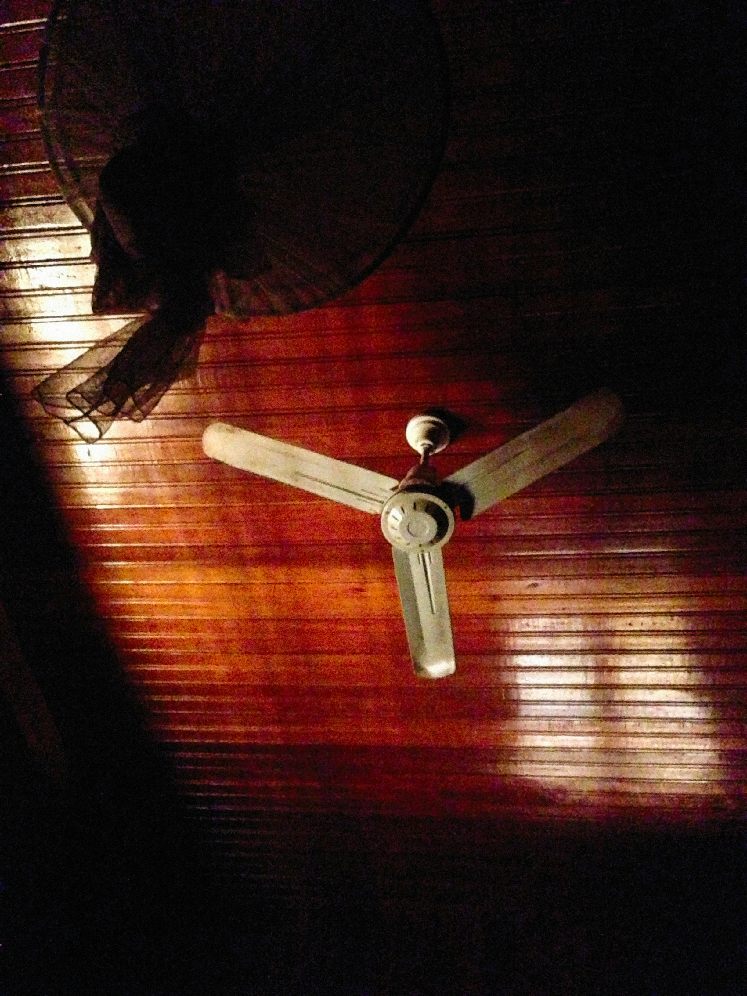 a ceiling fan sitting on top of a wooden floor