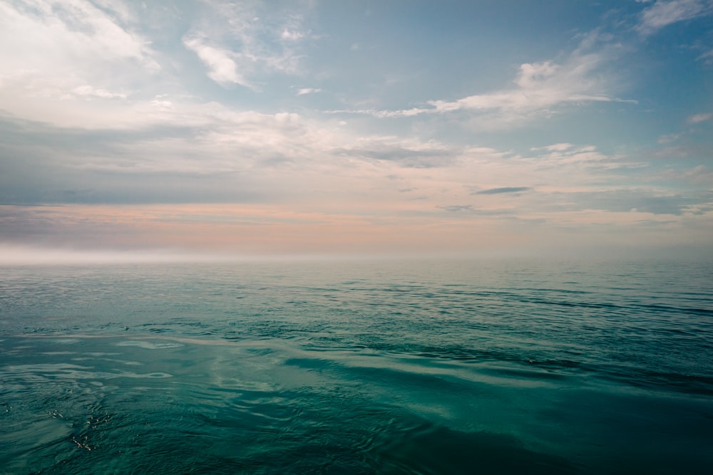 a large body of water under a cloudy sky