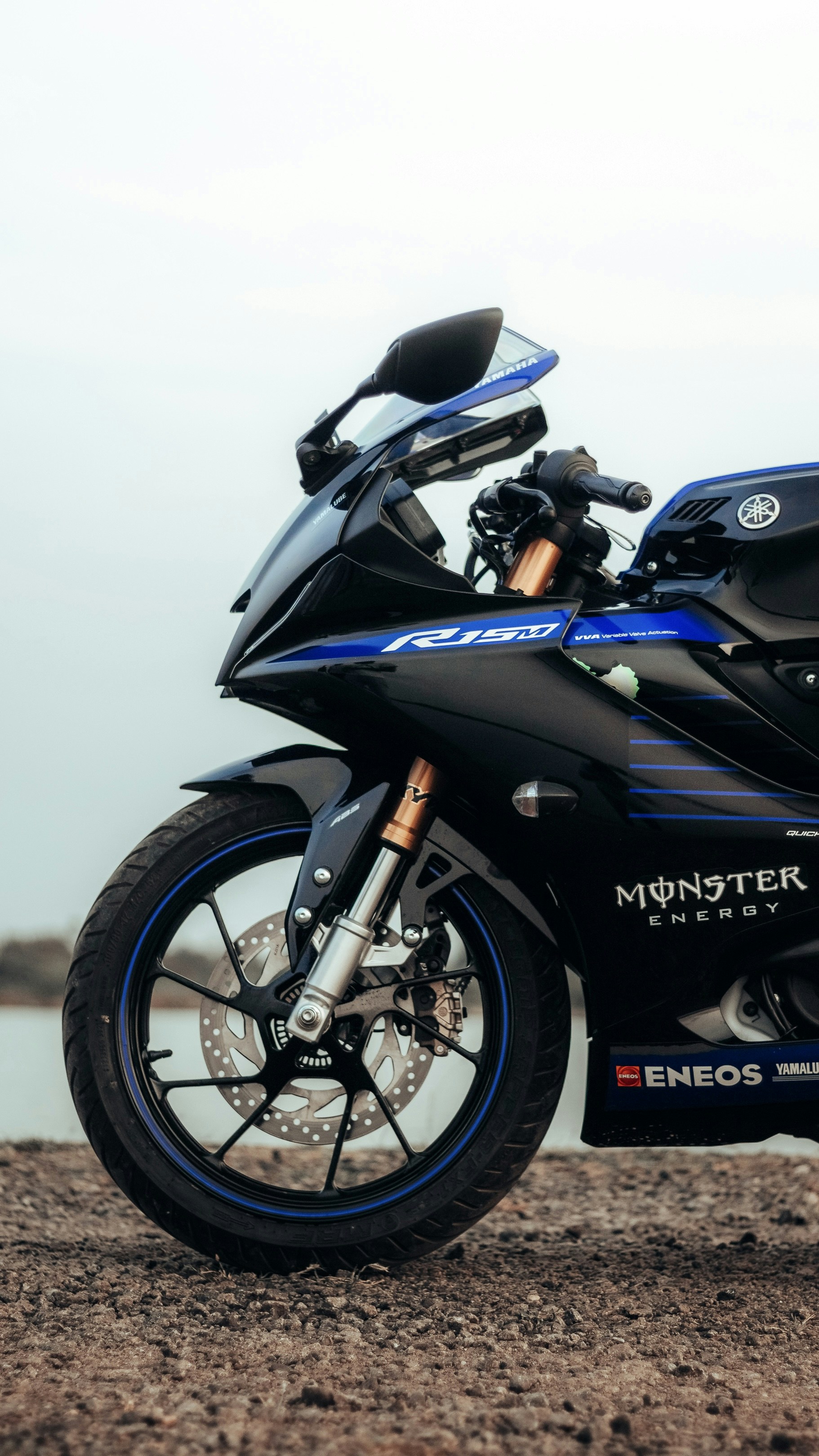 A blue and black motorcycle parked on a dirt road photo – Free ...