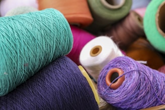 several spools of thread and spools of thread on a table