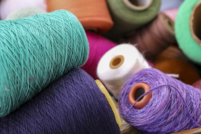 several spools of thread and spools of thread on a table