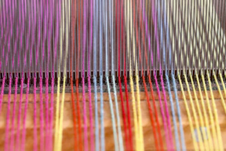 a close up of a colorful weaving machine