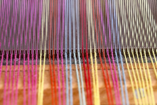 a close up of a colorful weaving machine