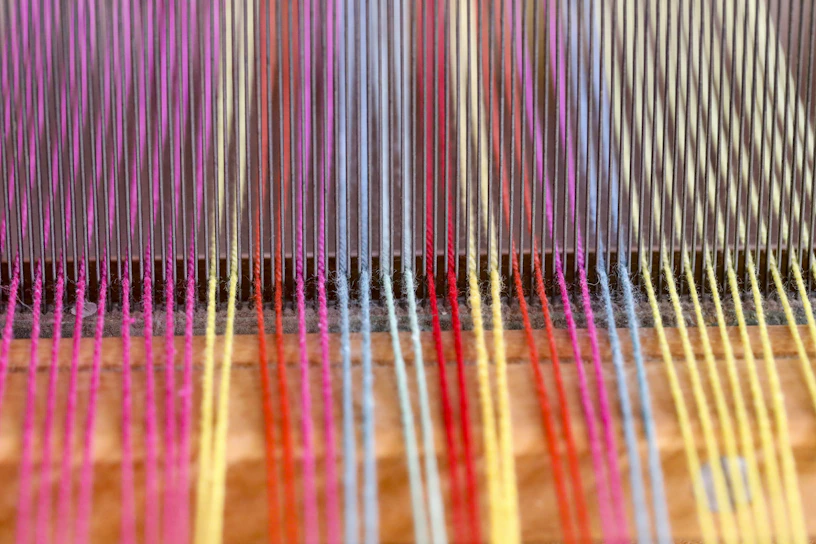 a close up of a colorful weaving machine