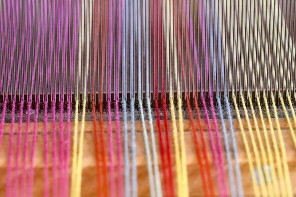 a close up of a colorful weaving machine