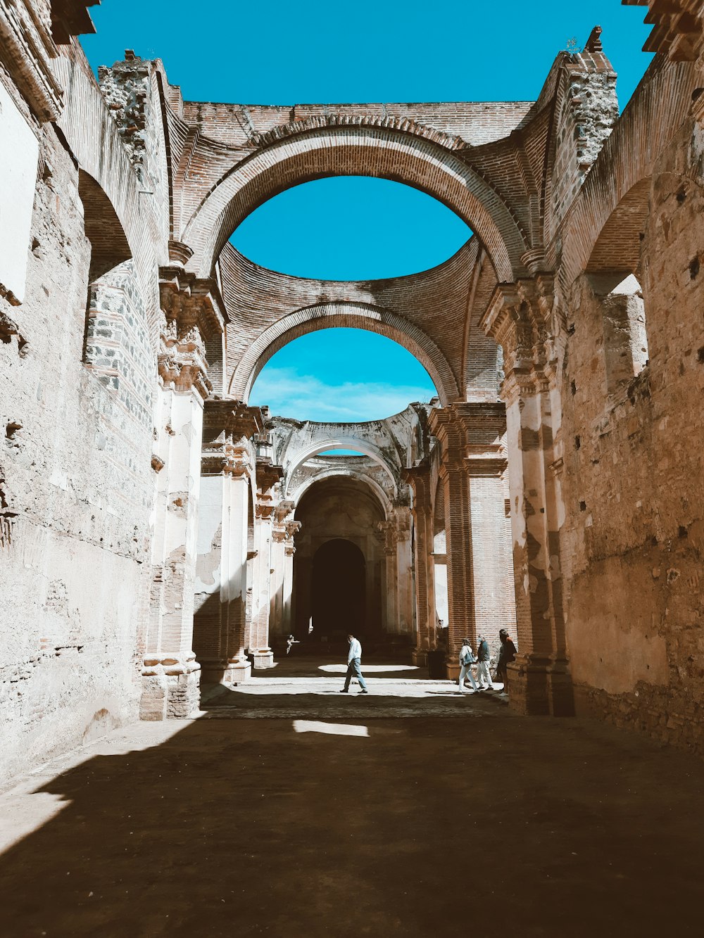 a couple of people are walking through an old building