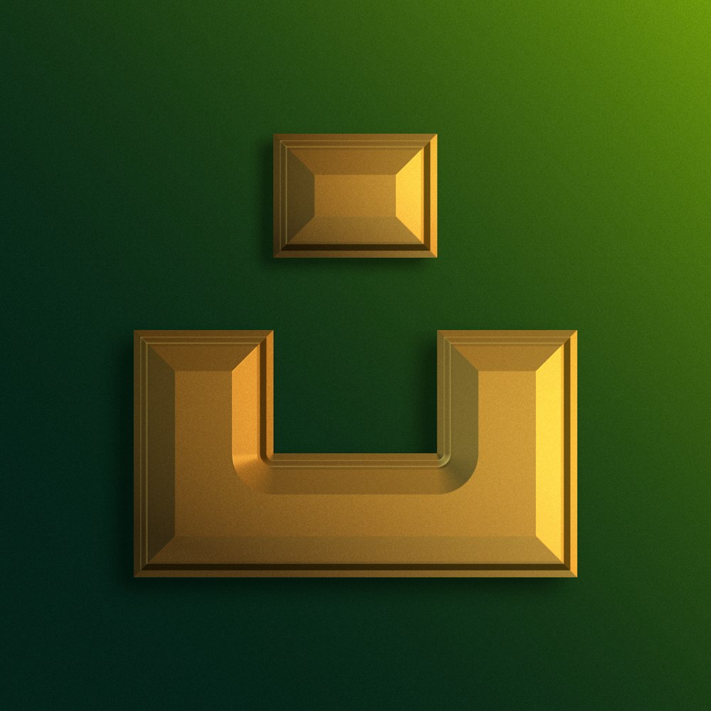 a green wall with two gold frames on it