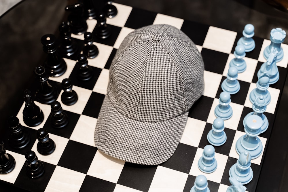 a hat sitting on top of a chess board