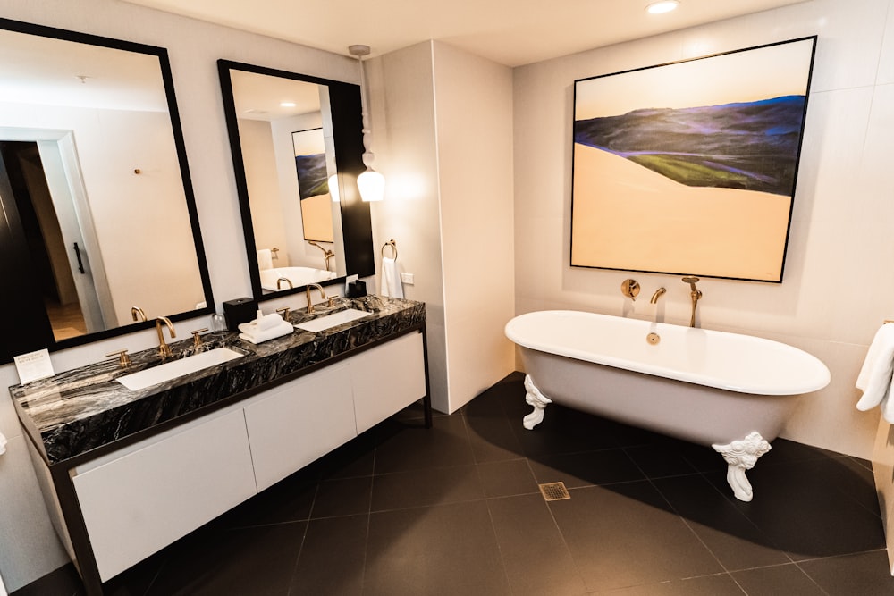 a bathroom with a tub, sink, and mirror