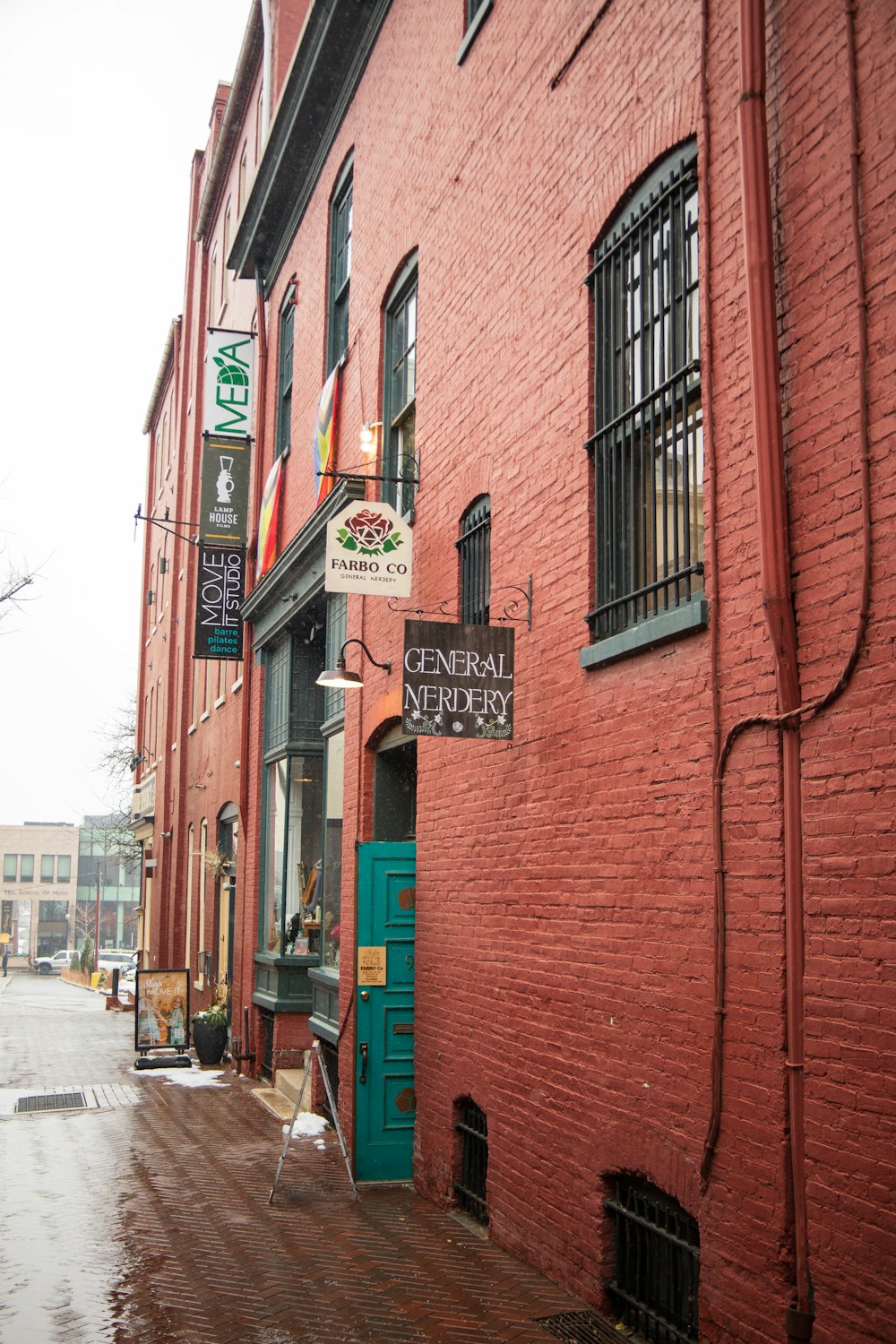 a red brick building with a green door