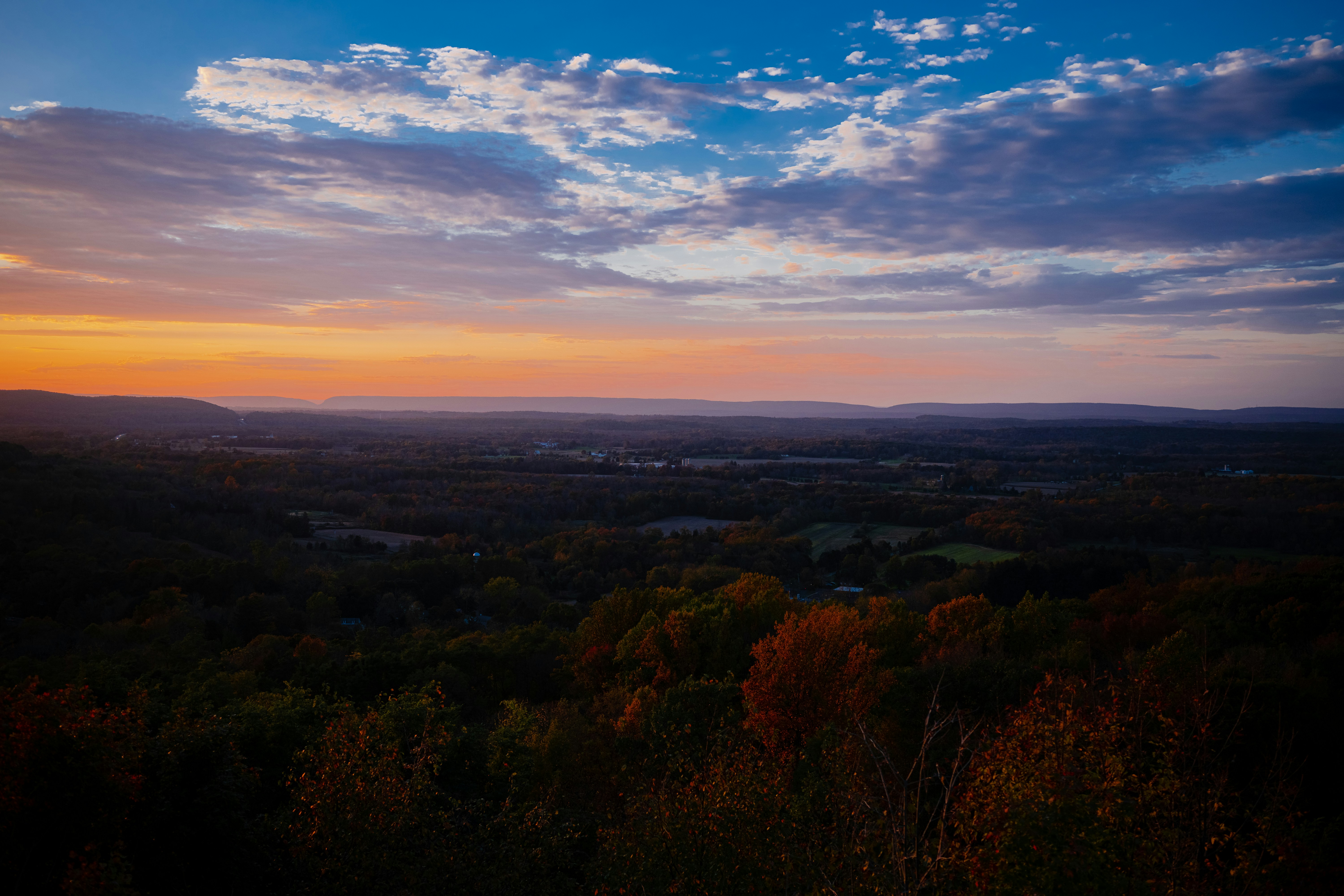a view of a sunset over a valley