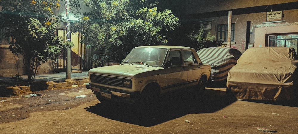 an old truck parked on the side of a road