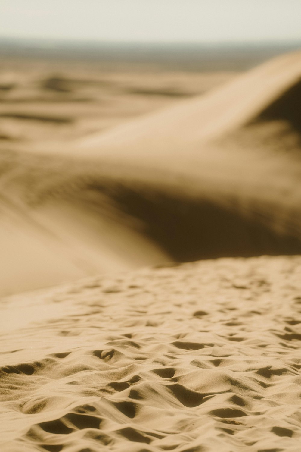 a blurry photo of sand dunes in the desert