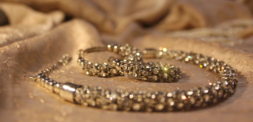 Close-up of sparkling gemstones arranged on a velvet cloth.