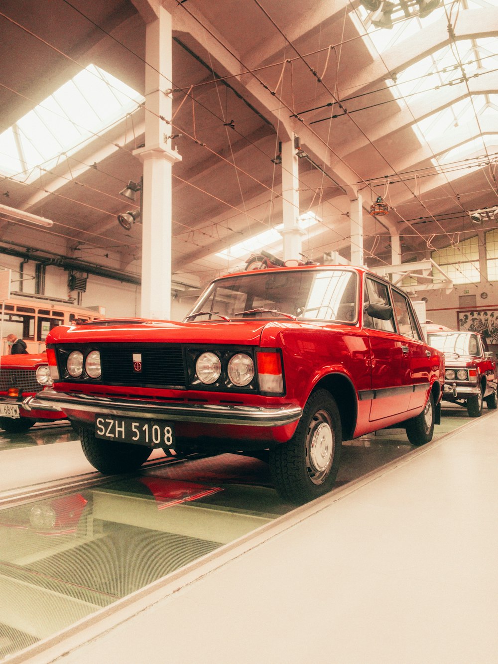 a red car parked inside of a garage