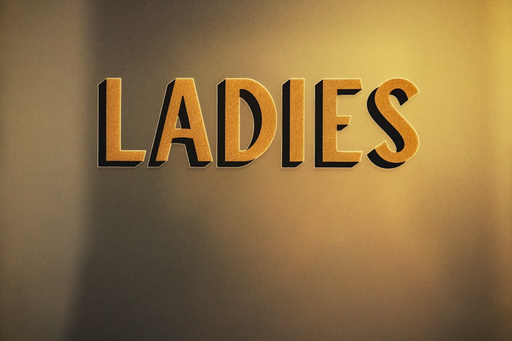 the word ladies spelled with cut out letters