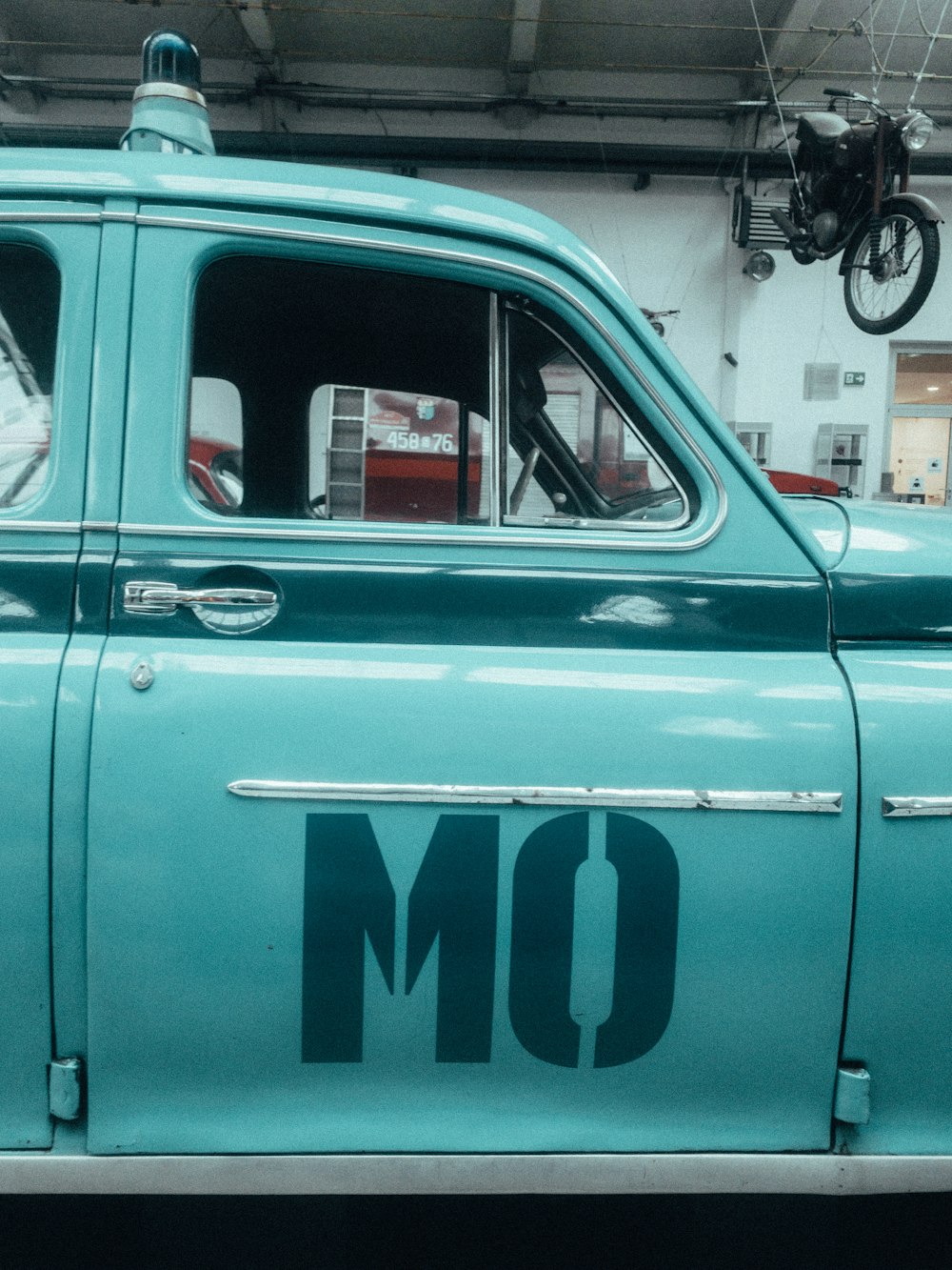 an old blue truck with the word om written on it