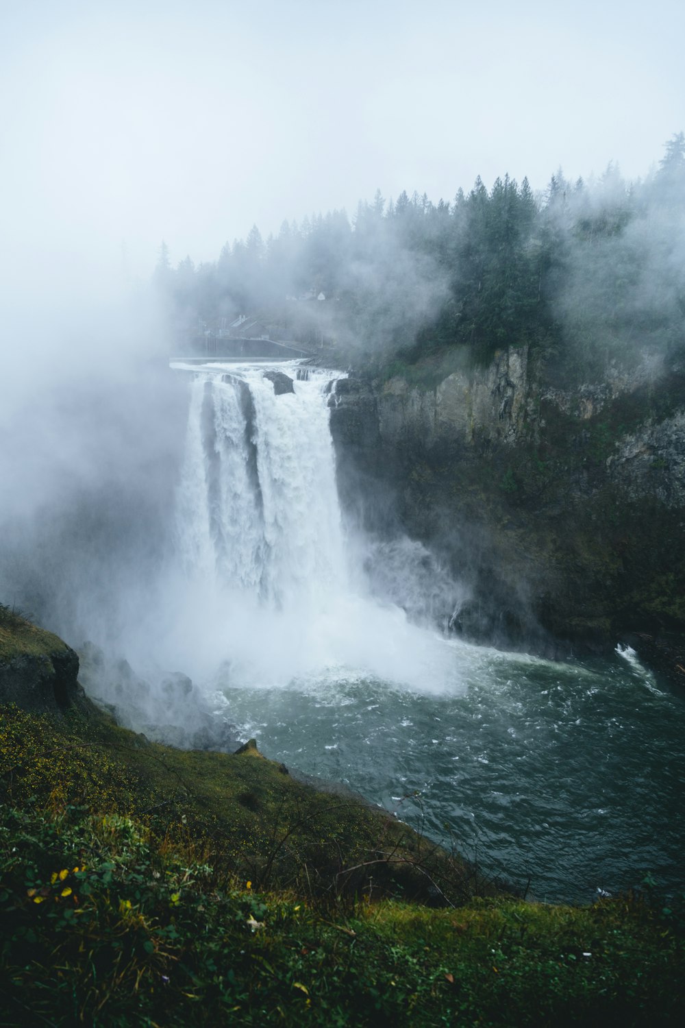 a waterfall in the middle of a body of water