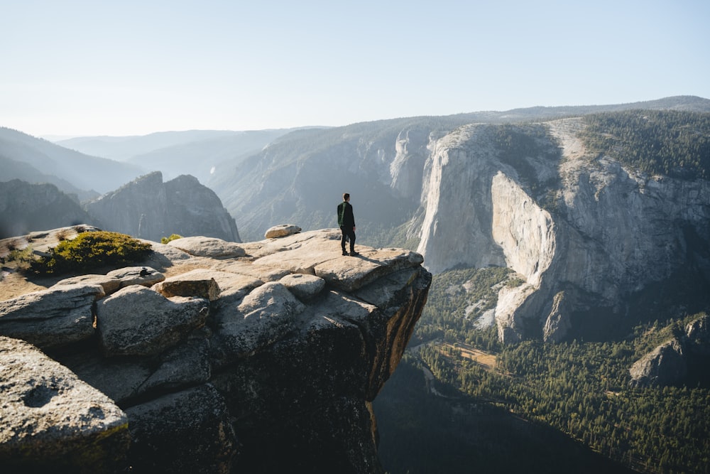 a person standing on top of a cliff