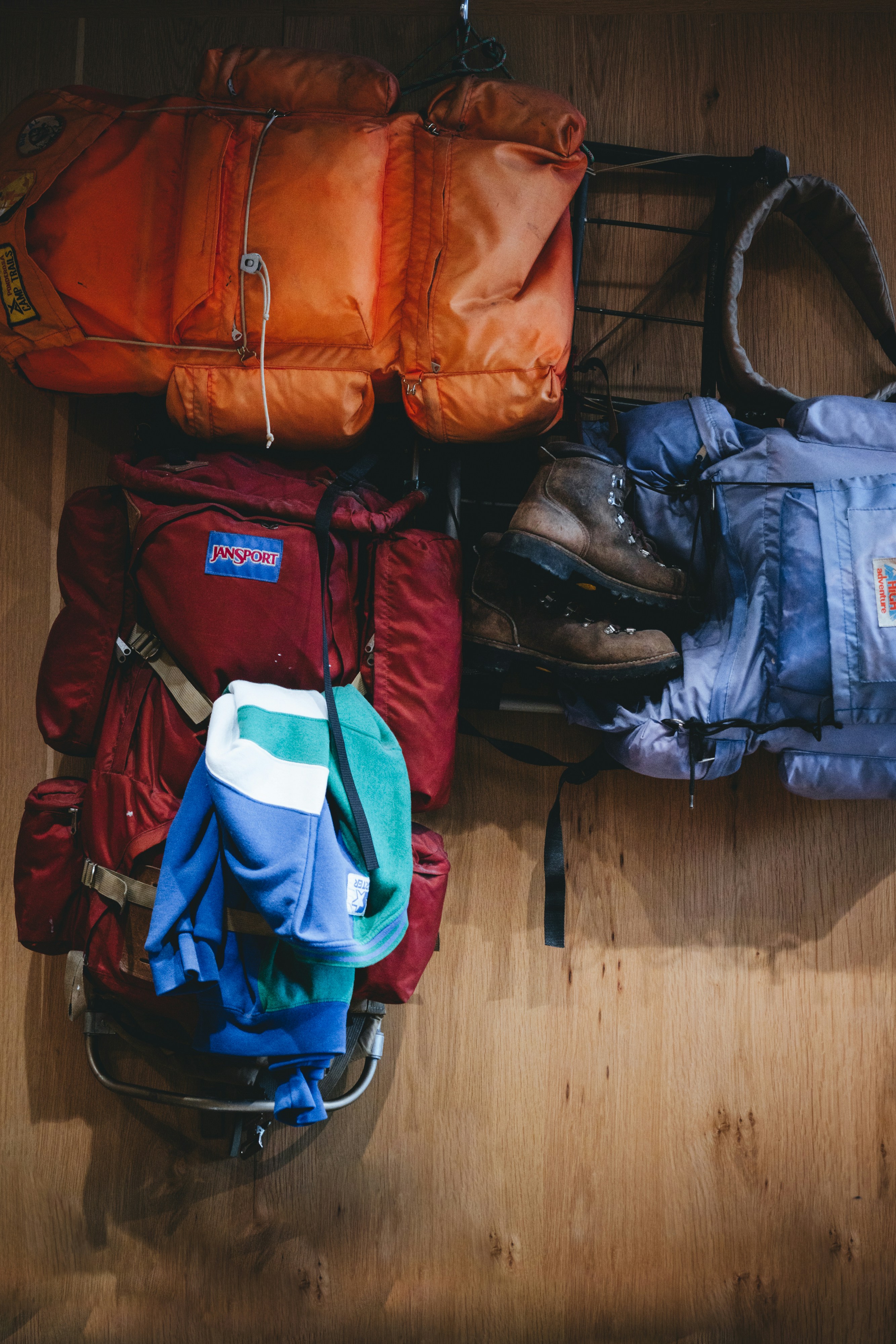 a pile of luggage sitting on top of a wooden floor
