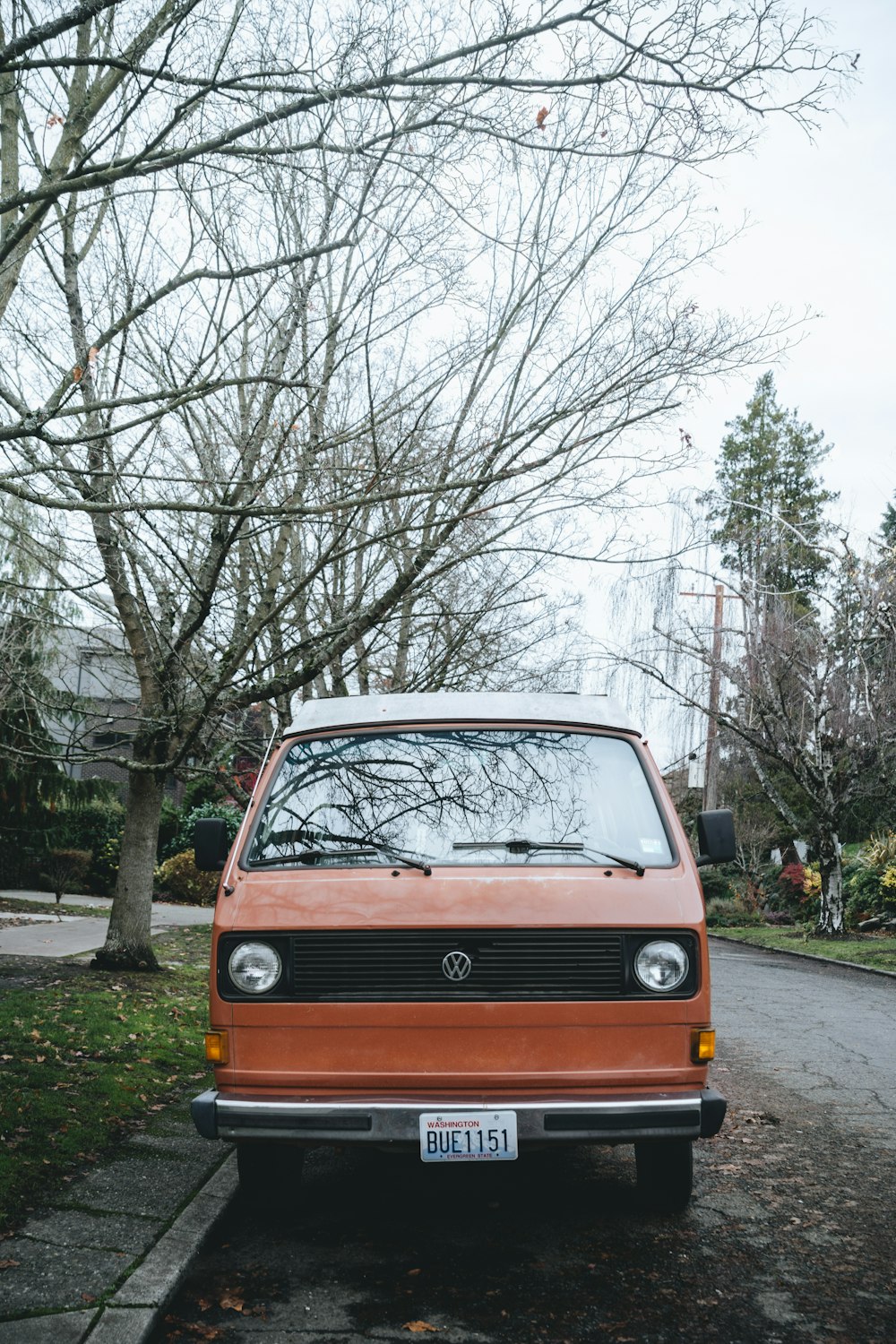 an orange van parked on the side of a road