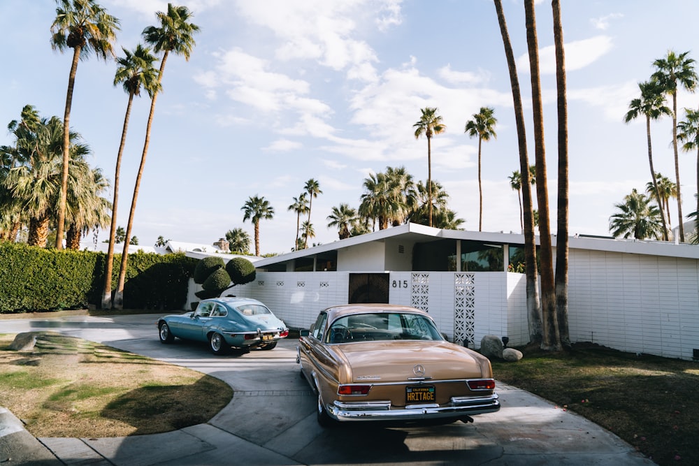 a couple of cars parked in front of a house