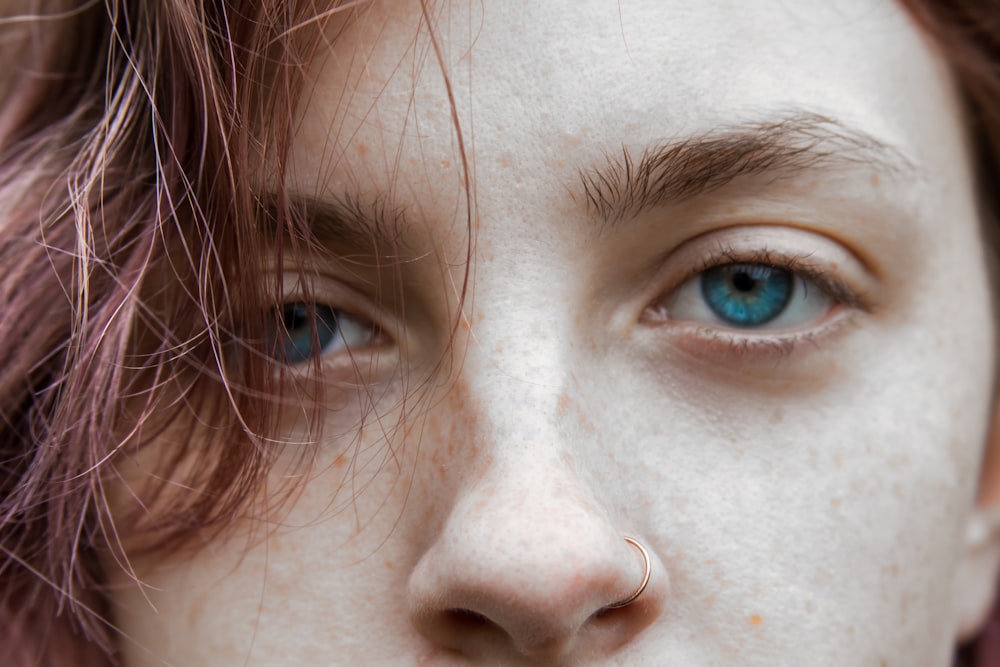 a woman with freckled hair and blue eyes