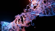 Close-up of DNA strands illuminated on a digital display in a darkened lab room.