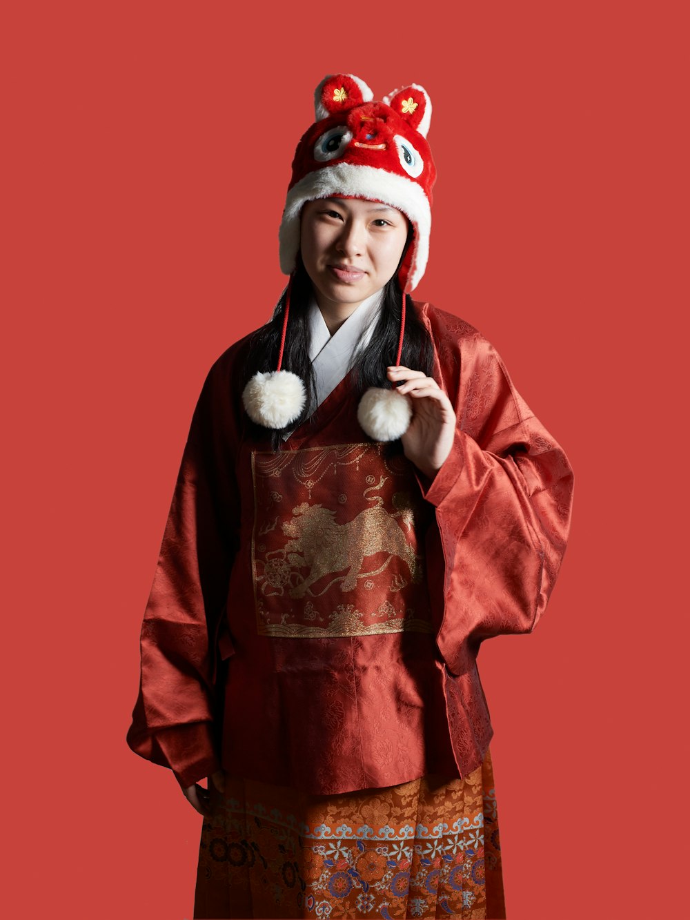 a woman in a red kimono and a white hat