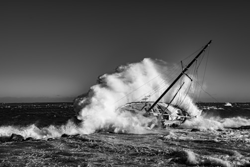 A stormy ocean scene with a distressed fishing boat battling high waves