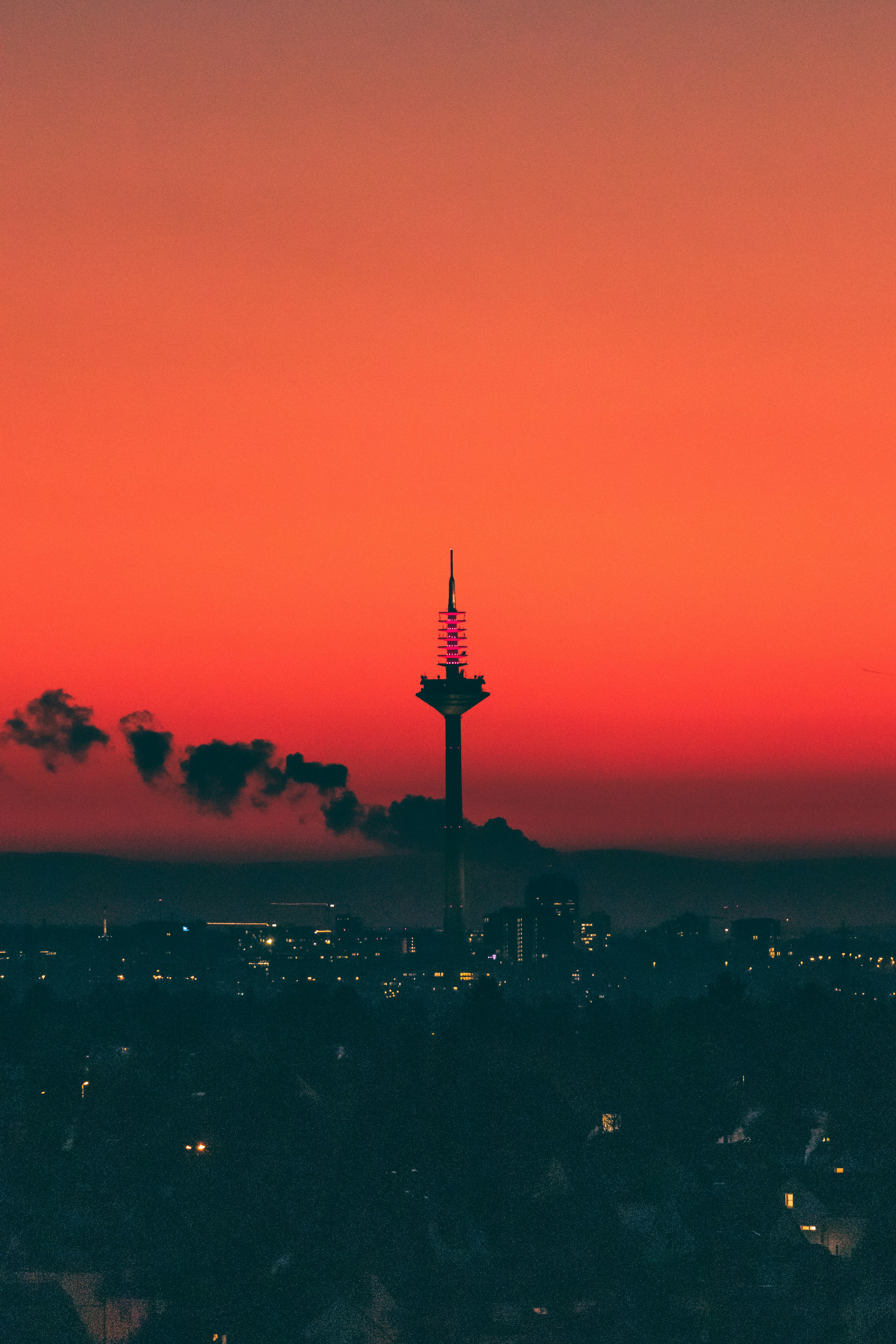 a view of a city at sunset with a red sky