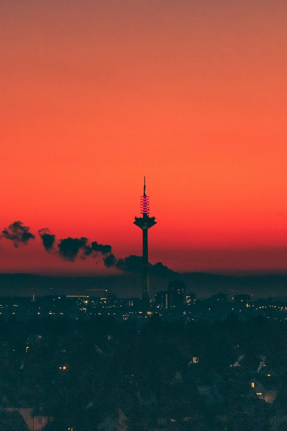 a view of a city at sunset with a red sky