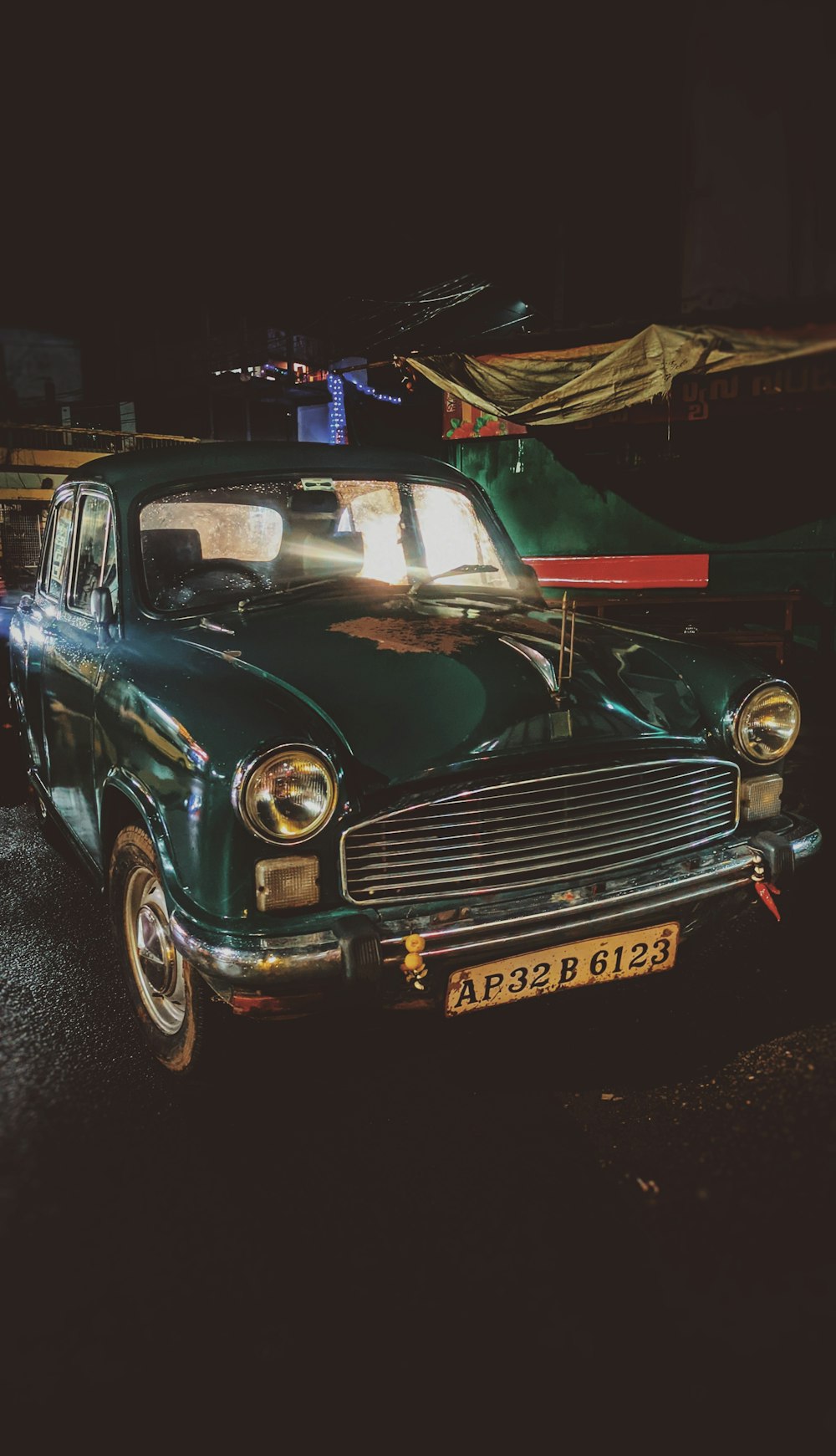 a green car parked on the side of the road