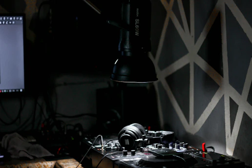 A cozy radio studio at night with soft lighting and a DJ relaxing while broadcasting